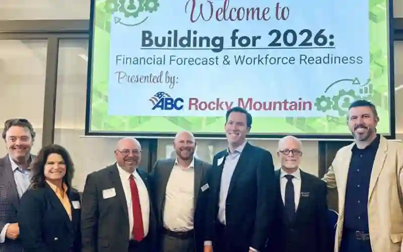 Uriah Kimmig stands with other industry leaders at the ABC Rocky Mountain Financial Forecast & Workforce Readiness event.